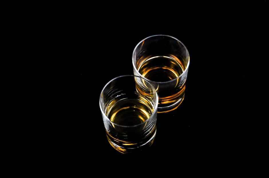 A pour of whiskey in low light